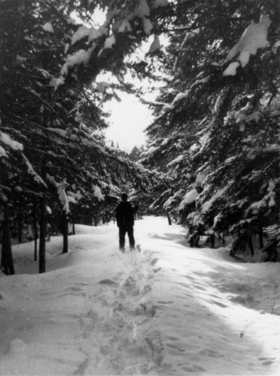 Charles Stone snowshoeing camp road, circa 1952